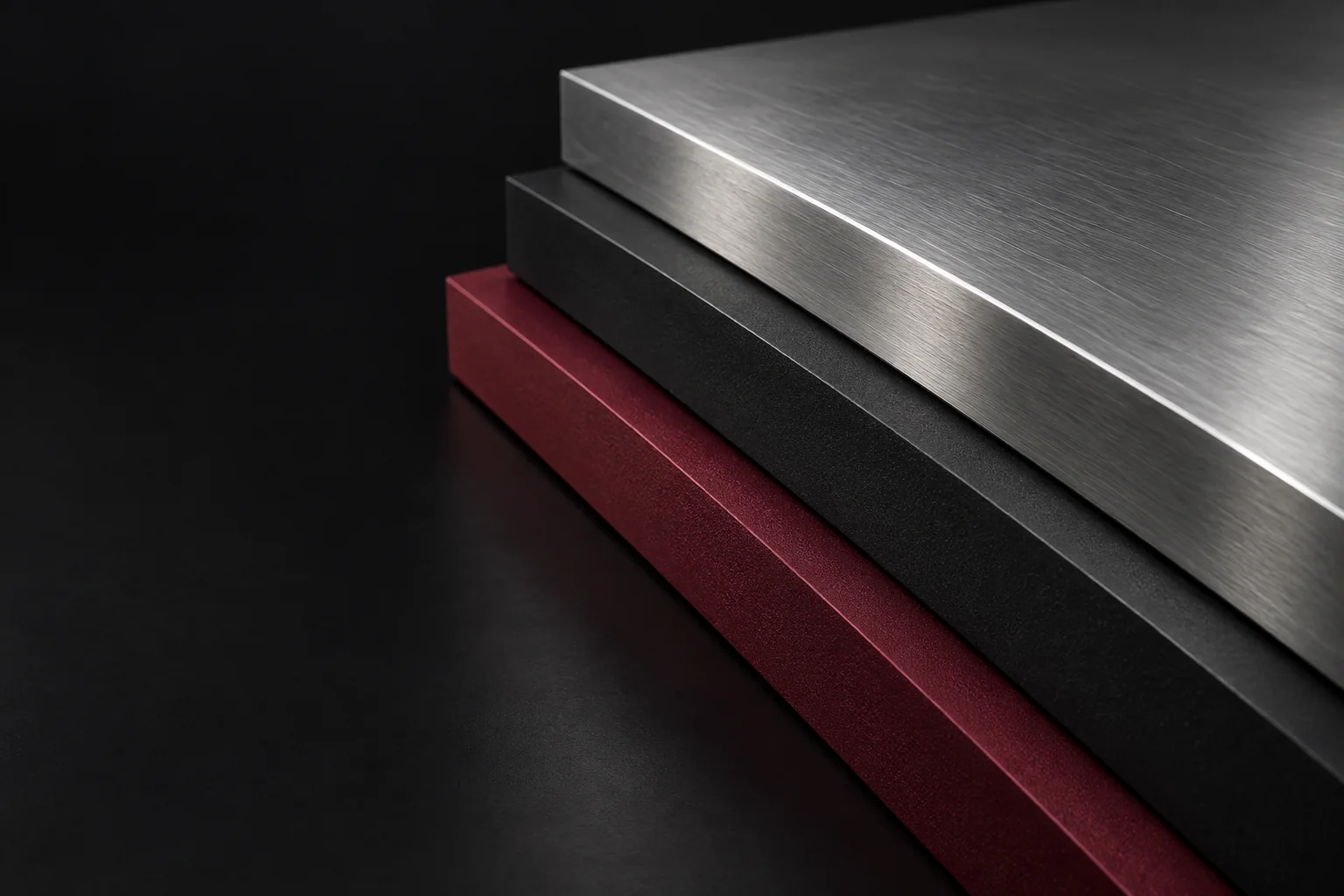 Precisely stacked layers of silver, charcoal, and maroon